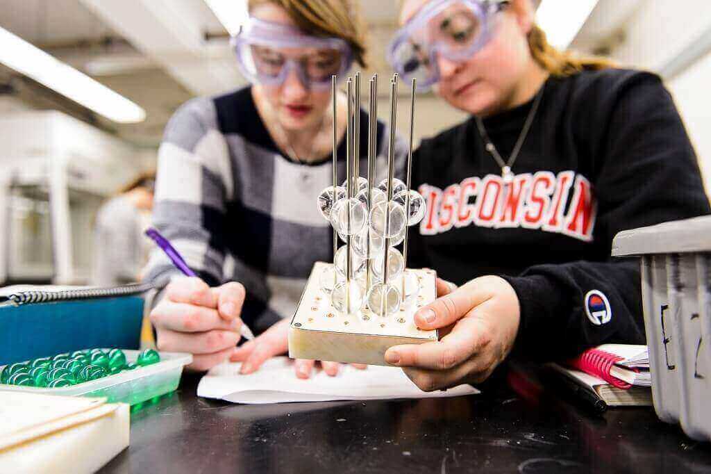 Undergraduate students Michelle Locke, left, and Bailey Spiegelberg conduct lab experiments and build three-dimensional molecular models of various solid-state materials during a UW–Madison chemistry class.