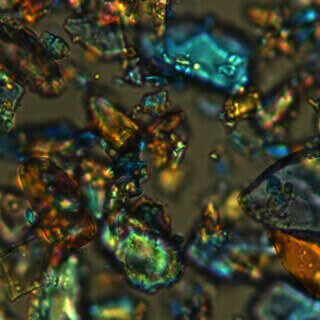 multi-colored floating crystals against distant brown background