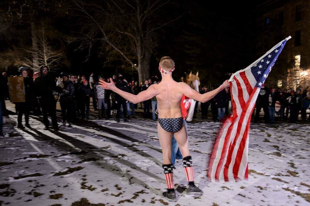 Photo: Guy in Speedo waving flag