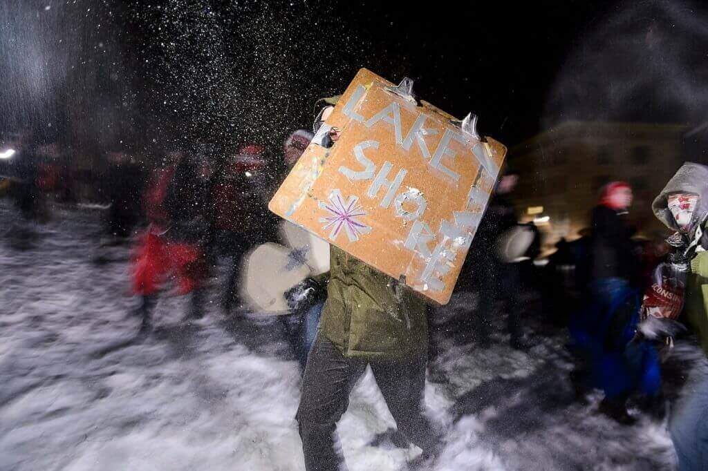 Photo: Student holding Lakeshore sign