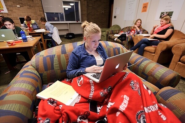 Photo: Student with laptop wearing earbuds