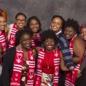 Karla Foster (blue stripes), coordinator for African American Student Academic Services, poses with happy graduates resplendent in their embroidered graduation stoles. 