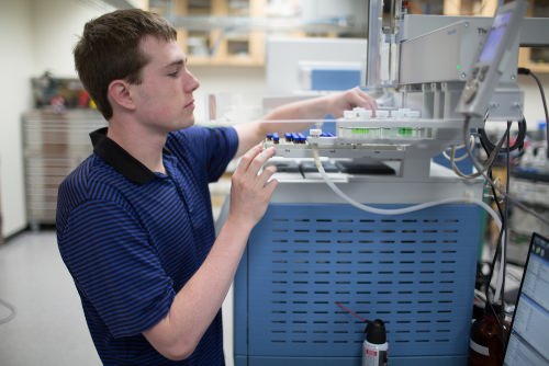 Photo: UW–Madison undergraduate Kyle Connors operates a mass spectrometer in the new NIH National Center for Quantitative Biology at UW–Madison. 