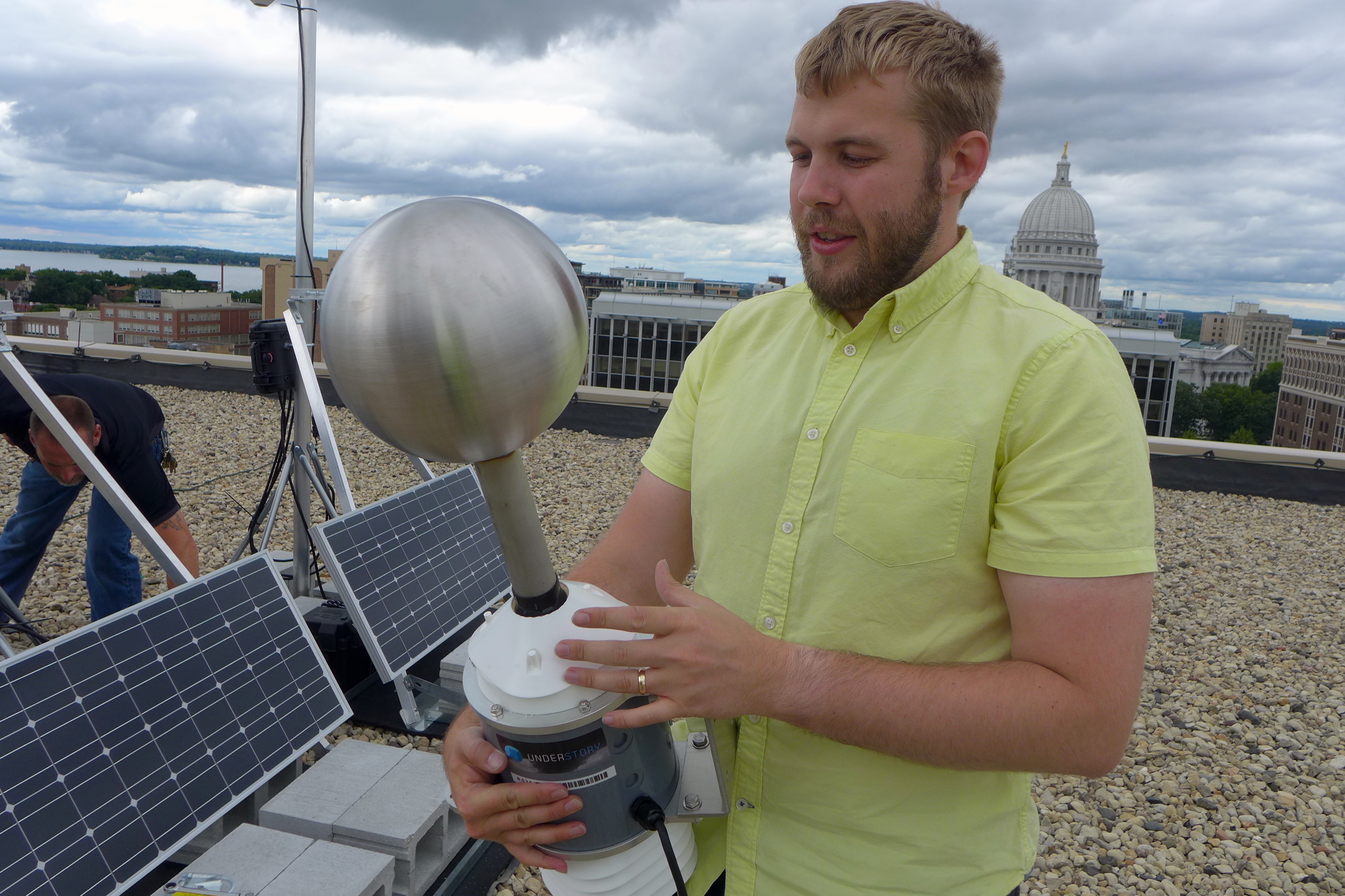 Alex Kubicek, CEO of Understory, holds one of the company's compact weather stations before it is mounted on the roof of the company’s West Washington Avenue headquarters in Madison. 