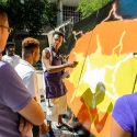 Chicago graffiti artist Lavie Raven (center), gives a demonstration of aerosol painting techniques. 