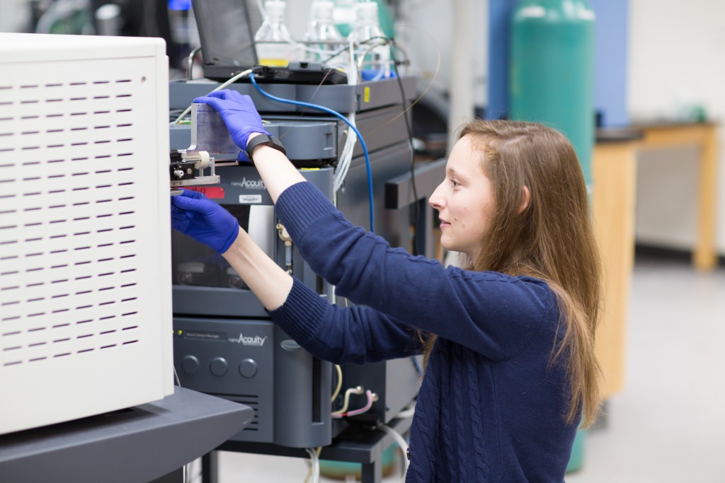 Photo: UW–Madison chemistry graduate student Emily Wilkerson prepares a mass spectrometer to analyze a mitochondrial protein sample.