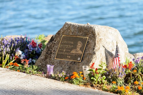 A memorial to former UW–Madison student John "Vietnam" Nguyen is pictured as the morning sun shines on Lake Mendota near the University of Wisconsin–Madison shoreline during summer on July 14, 2016. Nguyen, a member of the fifth cohort of the First Wave Spoken Word and Hip-Hop Arts Learning Community, lost his life while saving a friend from drowning on Aug. 30, 2012. (Photo by Jeff Miller/UW-Madison)