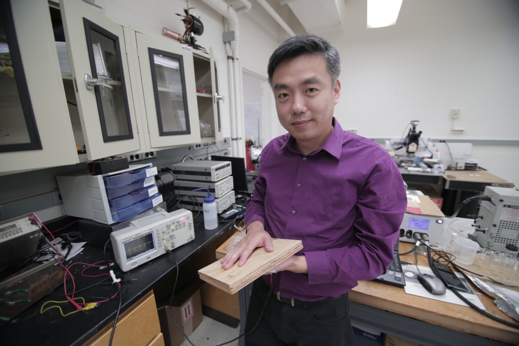 Photo: Associate Professor Xudong Wang holds a prototype of the researchers’ energy harvesting technology, which uses wood pulp and harnesses nanofibers. The technology could be incorporated into flooring and convert footsteps on the flooring into usable electricity.