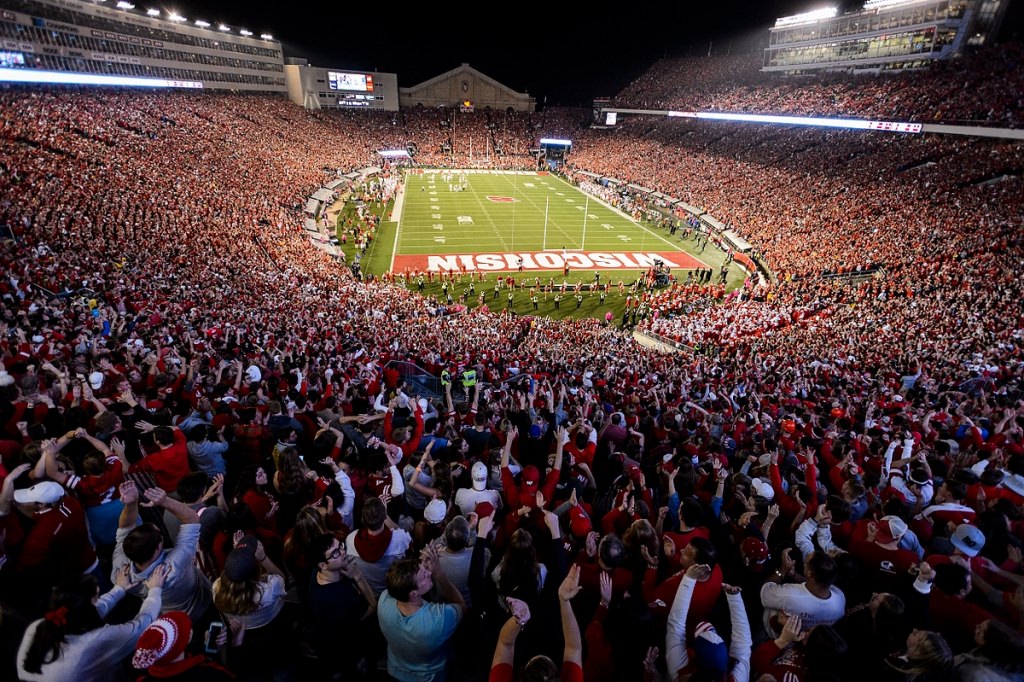 Badger fans cheer as the Wisconsin Badgers head into overtime play during a night football game against Ohio State in 2016.