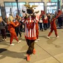 Bucky Badger waves to the thousands of spectators lining State Street.