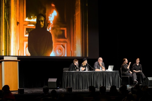 Sasha Bogina (table left) and Maria Alyokhina (table center), members of the Russian feminist punk group Pussy Riot, joined by Russian filmmaker Alexander Cheparukhin (table right), give a public talk about their activist experiences to a packed house inside the Memorial Union's Shannon Hall\.