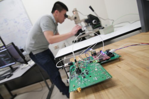 Using a top-of-the-line probing station combined with their own testing platform, Jing Li, left, and her students can diagnose reliability problems in their new computer chips.