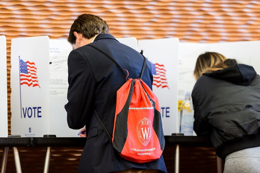 Photo: Student with backpack in polling booth