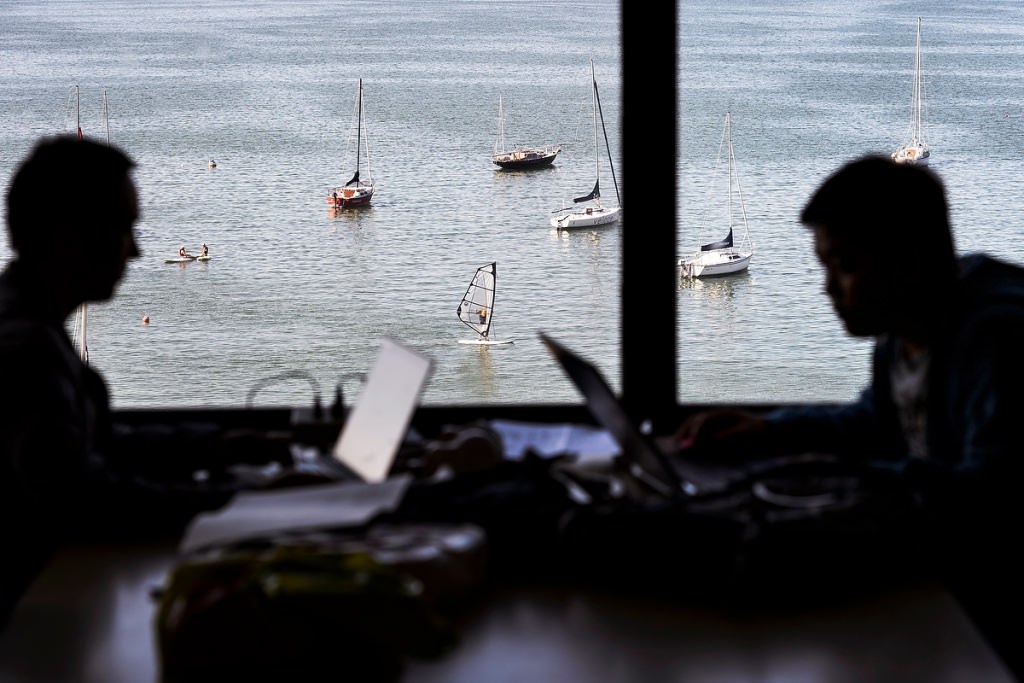 Photo: Students near window showing lake