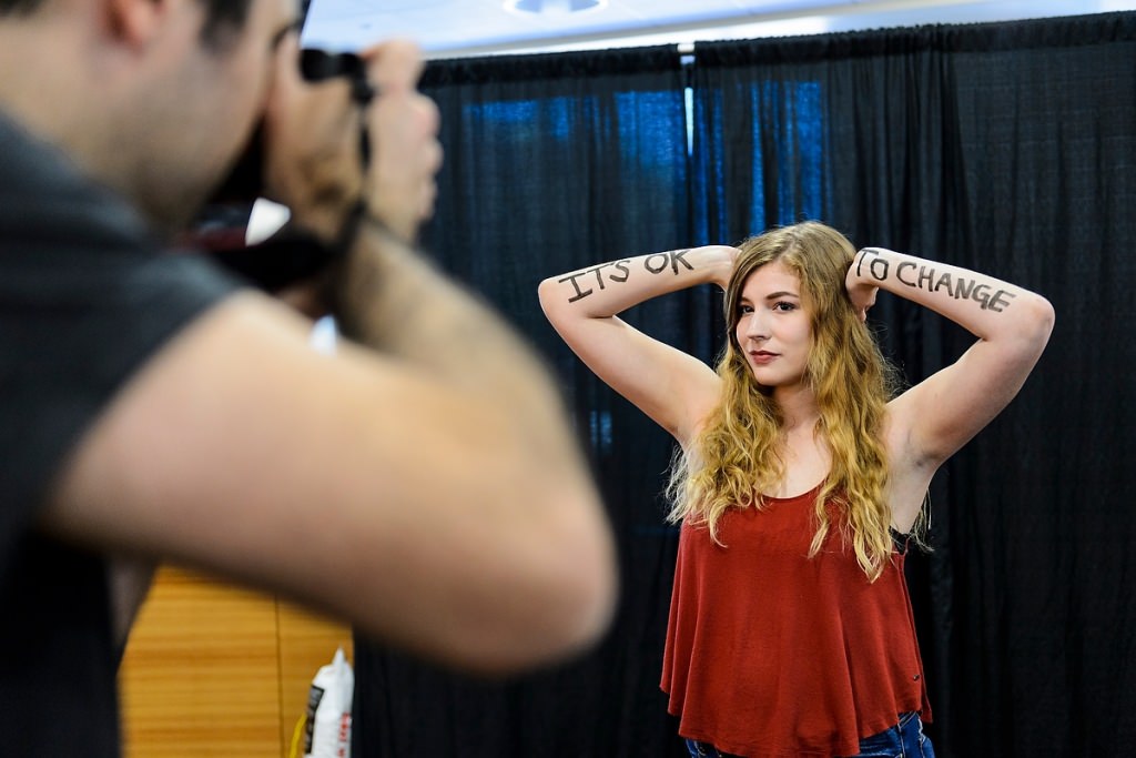 Photo: Student with It's Okay to Change written on arms