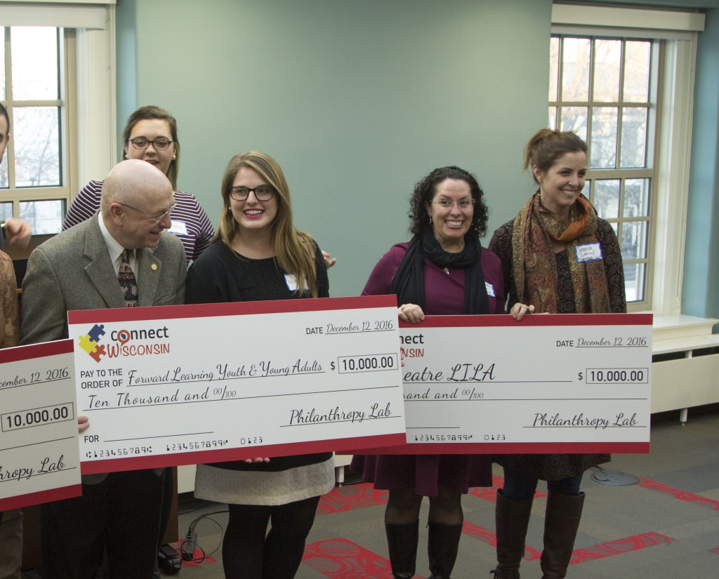 Representatives of nonprofit groups receive their checks for $10,000. The five groups were selected by the UW–Madison Philanthropy Lab class.