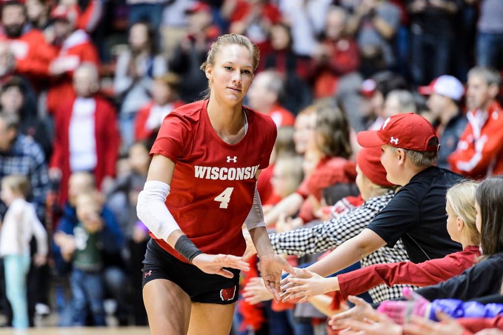 Photo: Wisconsin outside hitter Kelli Bates (4) is greeted by young Badger fans lining the court.