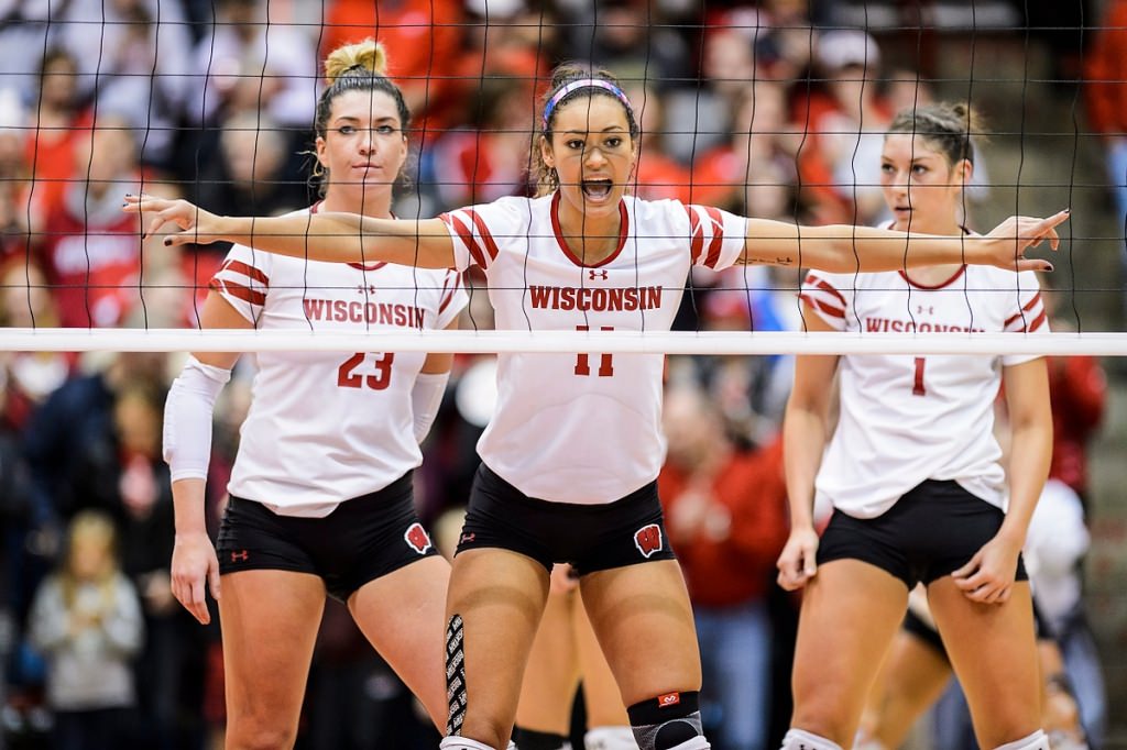 Photo: Wisconsin outside hitter Molly Haggerty (23), middle blocker Tionna Williams (11), setter Lauren Carlini (1) stand at the ready.