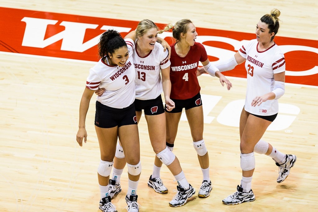 Photo: Wisconsin players Lauryn Gillis (3), Haleigh Nelson (13), Kelli Bates (4), Molly Haggerty (23) celebrate with teammates after their win.