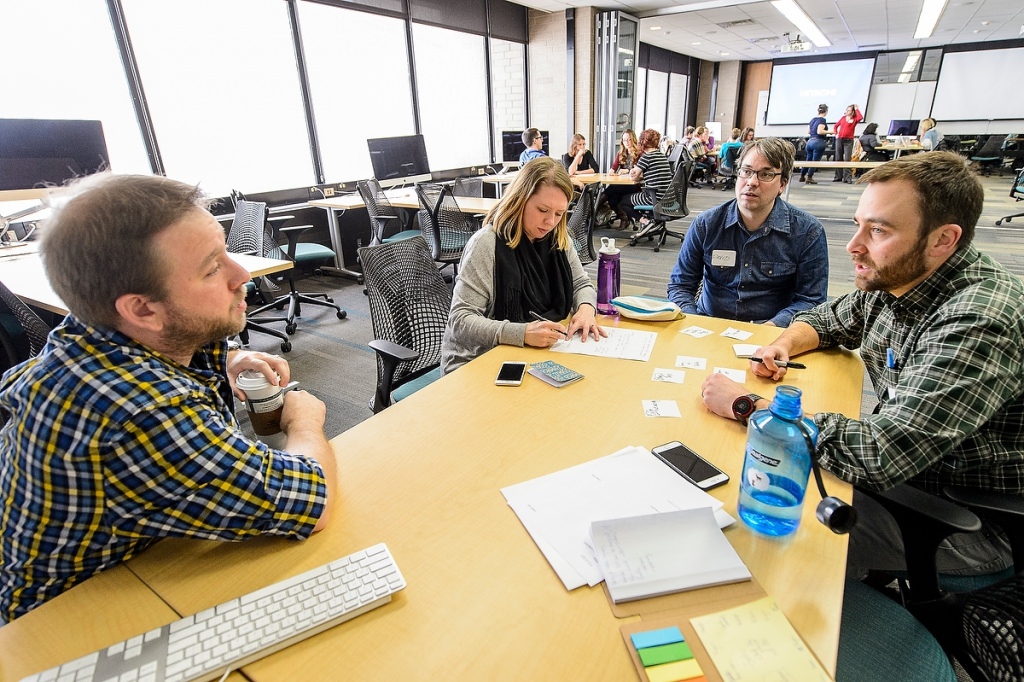 UW-Madison researcher David Gagnon (center) collaborates with Greg Vaughan (far left), staff at UW Games Education and Research (GEAR), Anna Jordan-Douglass (left), teaching assistant in the UW School of Education and Jake Eaton (right), science teacher at Madison Country Day School, during a Field Day Lab mini-game design workshop for K-12 Wisconsin science teachers held at the Wisconsin Institute for Discovery (WID) at the University of Wisconsin-Madison on Jan. 27, 2017. The educational outreach event is the hosted by the Wisconsin Institute for Discovery's Field Day Lab and focuses on designing and creating educational video games for their students and students across the country. (Photo by Bryce Richter / UW-Madison)