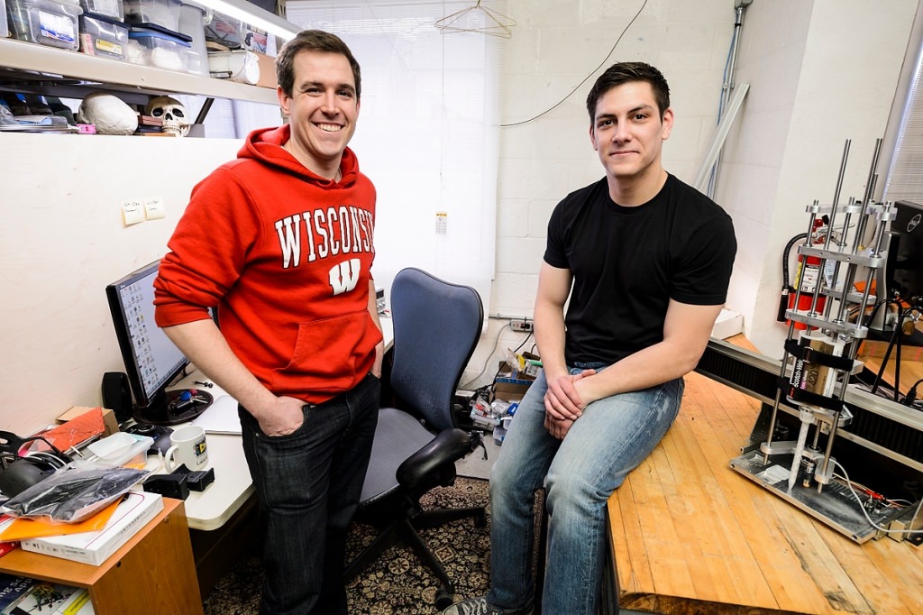 Brian Pekron, left, and Eric Ronning, CEO of Re Mixer Inc., make adjustments to an automated testing device. The Re Mixer nozzle promises to boost the effectiveness of mixing epoxy and hardener liquids to create industrial adhesives while also reducing nozzle waste. Ronning and Pekron, both 2015 engineering graduates of the University of Wisconsin–Madison, turned the idea into a business plan while participating in a Discover to Product (D2P) program at UW–Madison. 