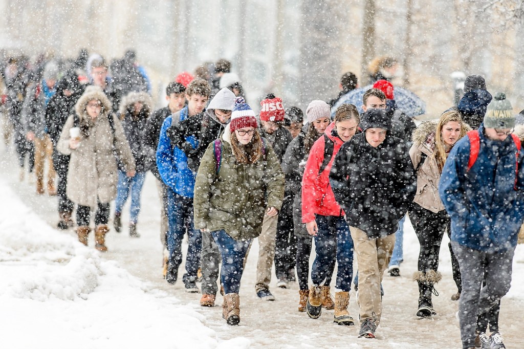 As a fresh coat of snow falls, students make their way to class.