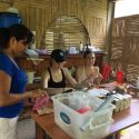 WWBM student director Jen Wagman, center, and operations coordinator Sophia Goldschmidt, right , work with local women to make necklaces during a trip to a Belina Jabon in Ecuador.
