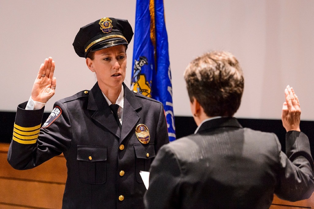 At left, UW Police Department Chief Kristen Roman pledges the Oath of Office to retired Police Chief Susan Riseling, right, during Roman's formal swearing-in ceremony at Union South's Marquee Cinema at the University of Wisconsin-Madison on Feb. 1, 2017. (Photo by Jeff Miller/UW-Madison)