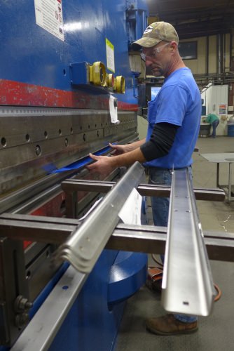 Photo: Worker bending conveyor supports