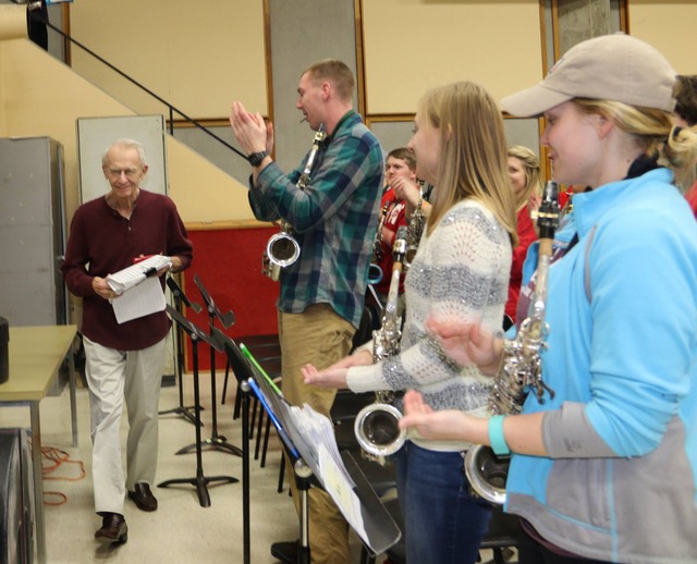 Varsity Band members applaud director Mike Leckrone as he returns to work March 15 following double bypass surgery.
