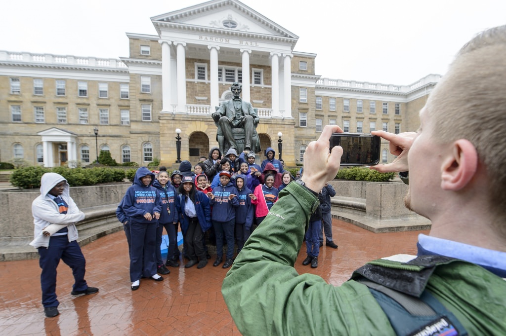 Students from the Milwaukee Excellence Charter School take a group photo during a tour of Bascom Hill where they learned about the history of its buildings and the Abraham Lincoln statue during a Bucky's Classroom event at the University of Wisconsin-Madison on April 27, 2017. Bucky's Classroom is a UW outreach program design to partner with K-8 Wisconsin schools to promote the value of higher education and provide classroom resources and an opportunity to directly engage with university students. (Photo by Bryce Richter / UW-Madison)