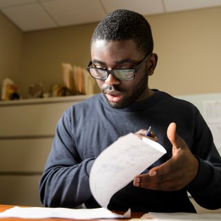 Kweku Brewoo, financial specialist in the School of Education at the University of Wisconsin-Madison, is pictured in his office in the Education Building on April 4, 2017. Brewoo is a recipient of a 2017 University Staff Recognition Award. (Photo by Bryce Richter / UW-Madison)