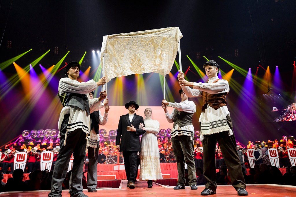 Members of Four Seasons Theatre perform a scene from "Fiddler on the Roof" during the 43rd annual UW Varsity Band Spring Concert at the Kohl Center at the University of Wisconsin-Madison on April 20, 2017. This year's concert, entitled "Nobody Does It Better: 20 Years at the Kohl," comes after band director Mike Leckrone's return to campus following recovery from a medical procedure this past winter. Leckrone is 80 and now in his 47th year at UW-Madison. (Photo by Jeff Miller/UW-Madison)
