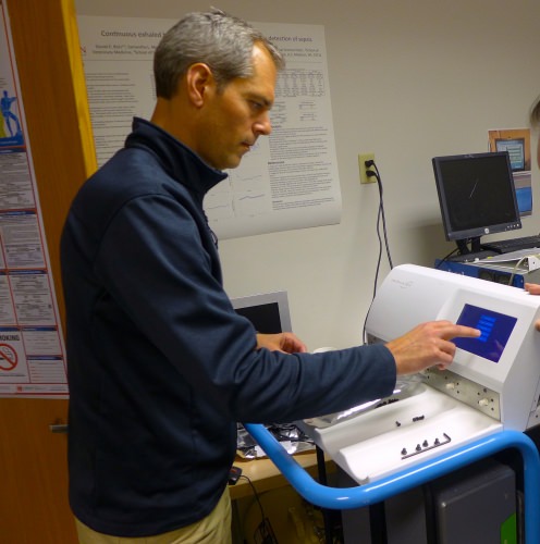 Isomark CEO Joe Kremer demonstrates the steps needed to measure carbon isotopes in a specimen container in Isomark’s instrument. Isomark is a spinoff from UW–Madison. 