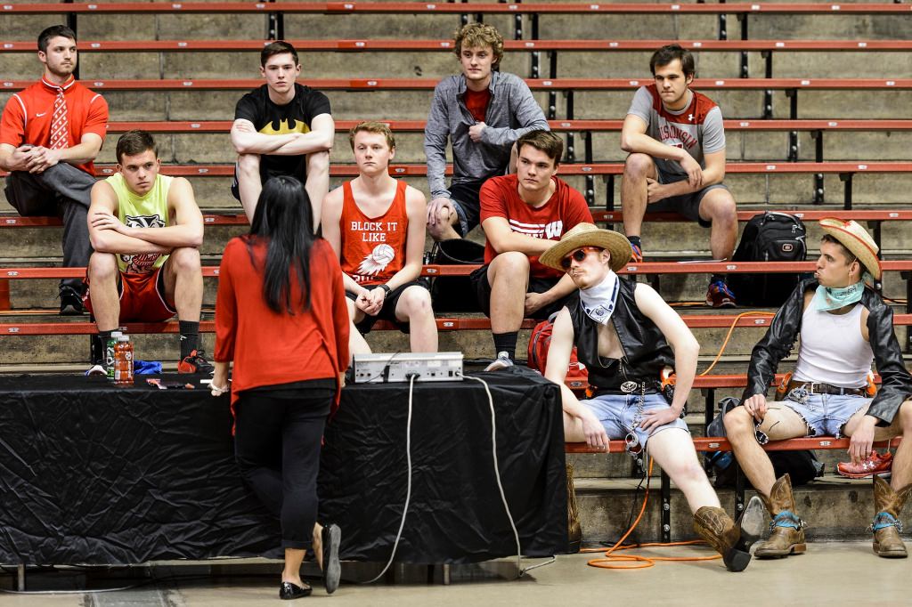 UW Spirit Squad Director Josette Jaucian talks to candidates at the start of preliminary tryouts for one of seven positions on the 2017-2018 Bucky Badger mascot team. Continuing a returning first-year Bucky tradition of adopting a unique persona, Devin Deegan, second from far right, and Seth Van Krey, far right, display plenty of cowboy-character machismo. The event was held at the Field House at the University of Wisconsin-Madison on April 17, 2017. Both Deegan and Van Krey remain on the team. (Photo by Jeff Miller/UW-Madison)