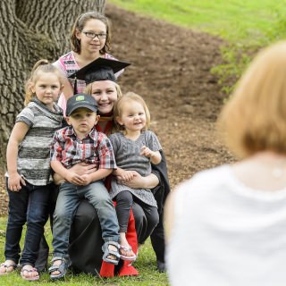 Graduate Katie Wilke takes a photo with members of her family prior to UW-Madison's spring commencement ceremony at Camp Randall Stadium at the University of Wisconsin-Madison on May 13, 2017. The outdoor graduation is expected to be attended by more than 6,000 bachelor's and master's degree candidates, and their guests. (Photo by Bryce Richter / UW-Madison)