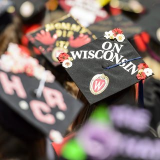 Graduates display personal messages on their graduation caps during UW-Madison's spring commencement ceremony at Camp Randall Stadium at the University of Wisconsin-Madison on May 13, 2017. The outdoor graduation is expected to be attended by more than 6,000 bachelor's and master's degree candidates, and their guests. (Photo by Bryce Richter / UW-Madison)