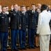 Members of UW-Madison's Army, Navy and Air Force ROTC units take the oath of office, led by Rear Admiral Stephen C. Evans, at right, during an officer commissioning ceremony at Gordon Dining and Event Center on May 13.