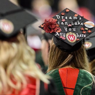 A graduate displays a decorated graduation cap during UW-Madison's spring commencement ceremony at the Kohl Center at the University of Wisconsin-Madison on May 12, 2017. The indoor graduation was attended by approximately 830 doctoral, MFA and medical student degree candidates, plus their guests. (Photo by Bryce Richter / UW-Madison)