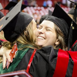 Graduates embraces one another in celebration during UW-Madison's spring commencement ceremony at the Kohl Center at the University of Wisconsin-Madison on May 12, 2017. The indoor graduation was attended by approximately 830 doctoral, MFA and medical student degree candidates, plus their guests. (Photo by Bryce Richter / UW-Madison)