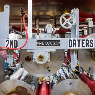 Participants toured the paper lab at UWÐStevens Point. The lab was a place where industry, science, nature and history came together. Shown is a Nekoosa dryer in the lab. Nekoosa is derived from a Ho-Chunk word meaning Òrunning water.Ó Water was a major topic in its role producing paper.