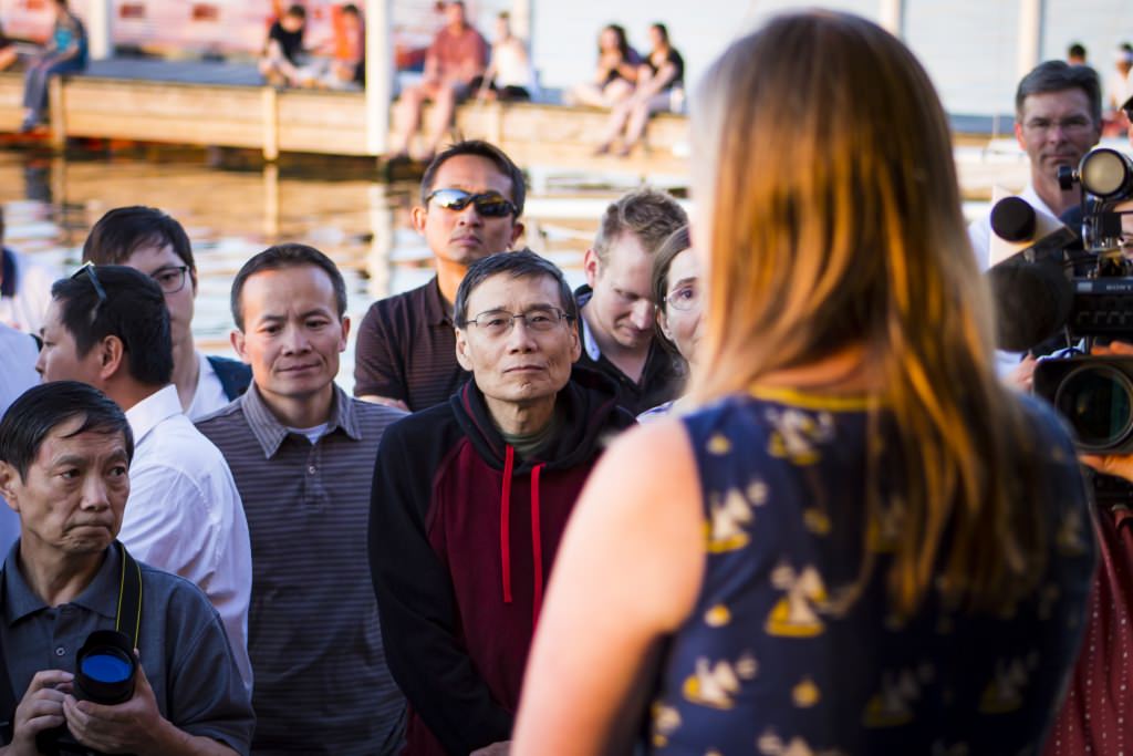 A friend of Yu Chen who sailed with him speaks to family and friends who attended the candlelight vigil.