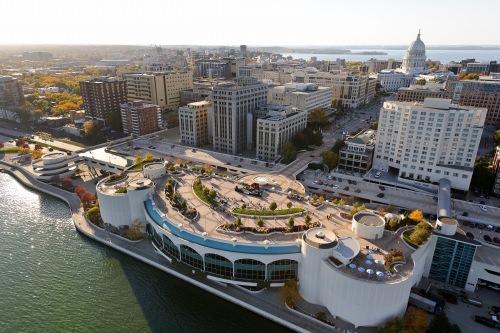 Counter clockwise from lower left, Lake Monona, the Monona Terrace Community and Convention Center, and Wisconsin State Capitol are pictured in an aerial view of the downtown Madison skyline during an autumn sunset on Oct. 5, 2011. In the background, right of center, is the University of Wisconsin–Madison campus, Picnic Point and Lake Mendota. The photograph was made from a helicopter looking west. (Photo by Jeff Miller/UW-Madison)