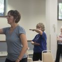 Diane Brose, left, leads a tai chi class in La Crosse. Phyllis Branson, right, says, “I’m very aware of being able to maintain my balance.” Chairs are used to guard against falls in the class.
