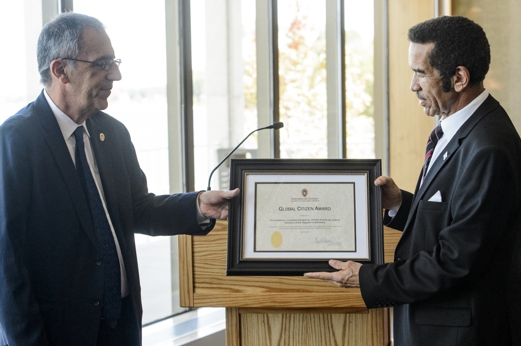 Guido Podesta (left), dean of the Division of International Studies, presents a Global Citizen Award to Ian Khama (right), president of the Republic of Botswana during a lunch ceremony attended by members of the UW community, including the Mandela-Washington Fellows, held in the Alumni Lounge of the Pyle Center at the University of Wisconsin-Madison on July 28, 2017. (Photo by Bryce Richter / UW-Madison)
