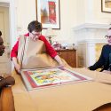 UW-Madison Chancellor Rebecca Blank receives a gift of artwork from alumnus and local artist Michael Ward, left, on Aug. 16.