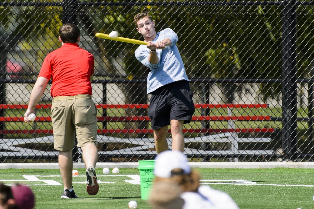 Photo: Connor Akers swinging bat at whiffle ball