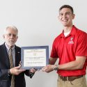 Army ROTC cadet Kai Pederson (right), a UW-Madison junior, receives the Distinguished Achievement Scholarship from Ronald T. Rand (left), a retired U.S. Air Force brigadier general and president and CEO of the Congressional Medal of Honor Foundation, during a ceremony.