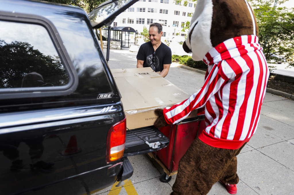 Photo: Bucky helping unload a box from a car