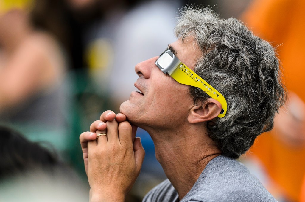 Tony Zappia, a UW-Madison Fall 1991alumnus with a degree in political science, wears solar-filtered eyeglasses to observe the moon as it passes orbit in front of the sun for a maximum 85-percent solar eclipse -- as seen at the Memorial Union Terrace at the University of Wisconsin-Madison --on Aug. 21, 2017. AA total-solar eclipse was visible, for the first time in almost 100 years, along a coast-to-coast path across the middle of the United States from Oregon to the Carolinas. (Photo by Jeff Miller / UW-Madison)